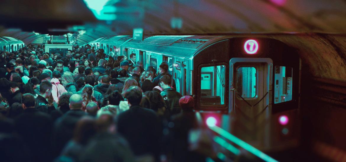 People crowding to get onto a train