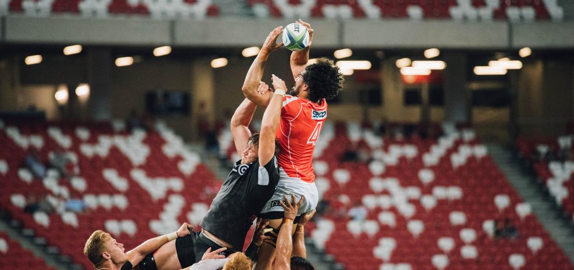 Rugby players jumping for ball at lineout