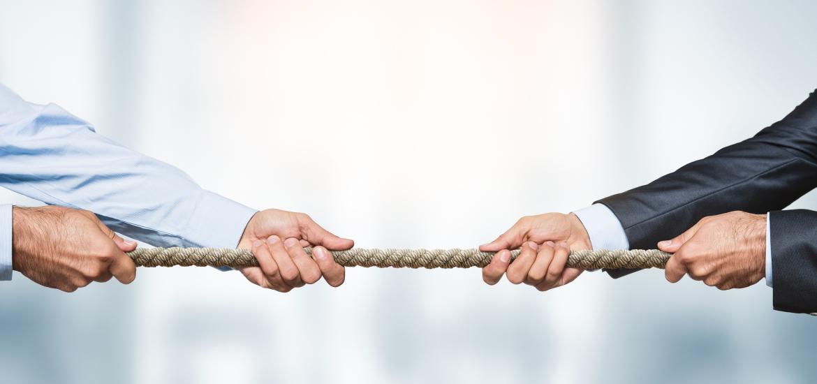 Men's hands holding rope for tug of war