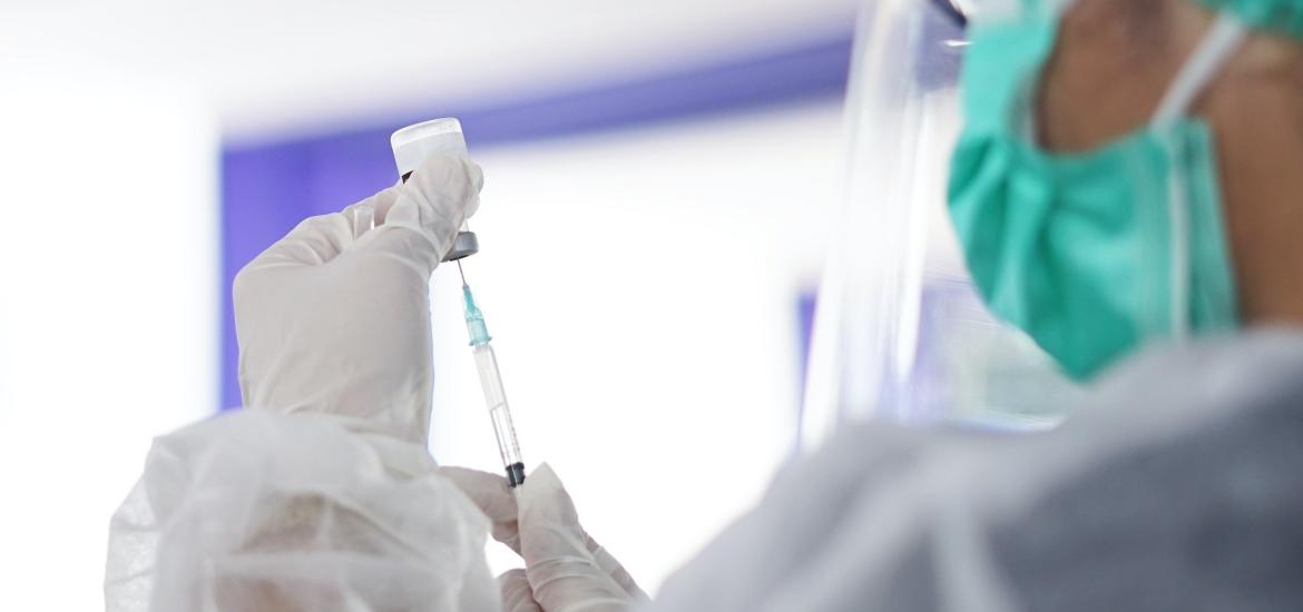 Healthcare worker with vial and needle vaccine