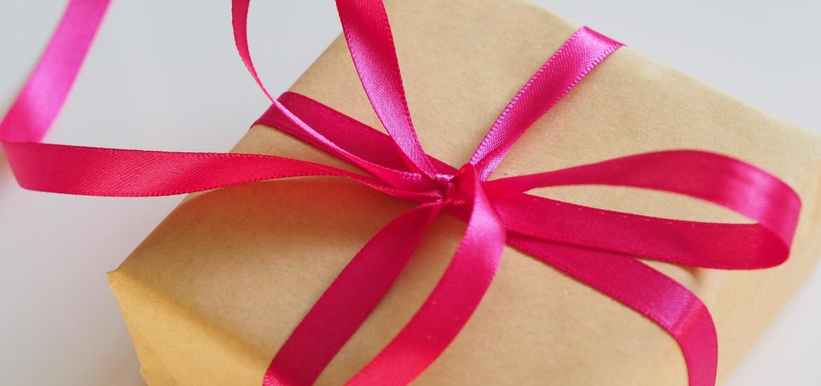 Present wrapped up with pink ribbon around it